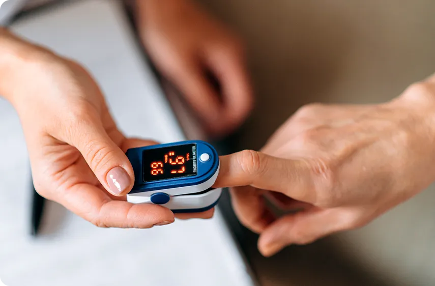 A person using a pulse oximeter  