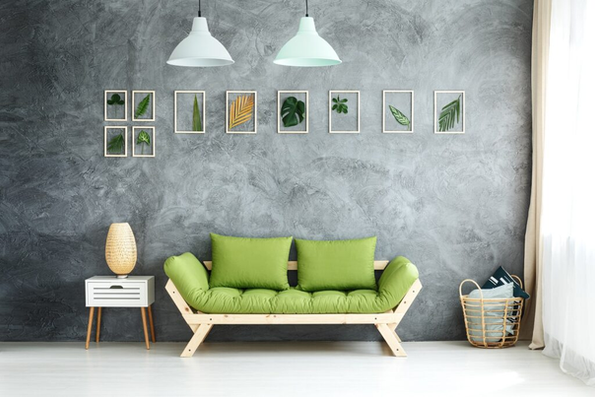 Modern living room with a grey wall and green sofa