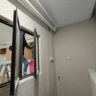 Electrical contractor installing new plug point in kitchen