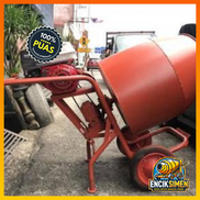 Contractor inspecting newly delivered cement mixer machine
