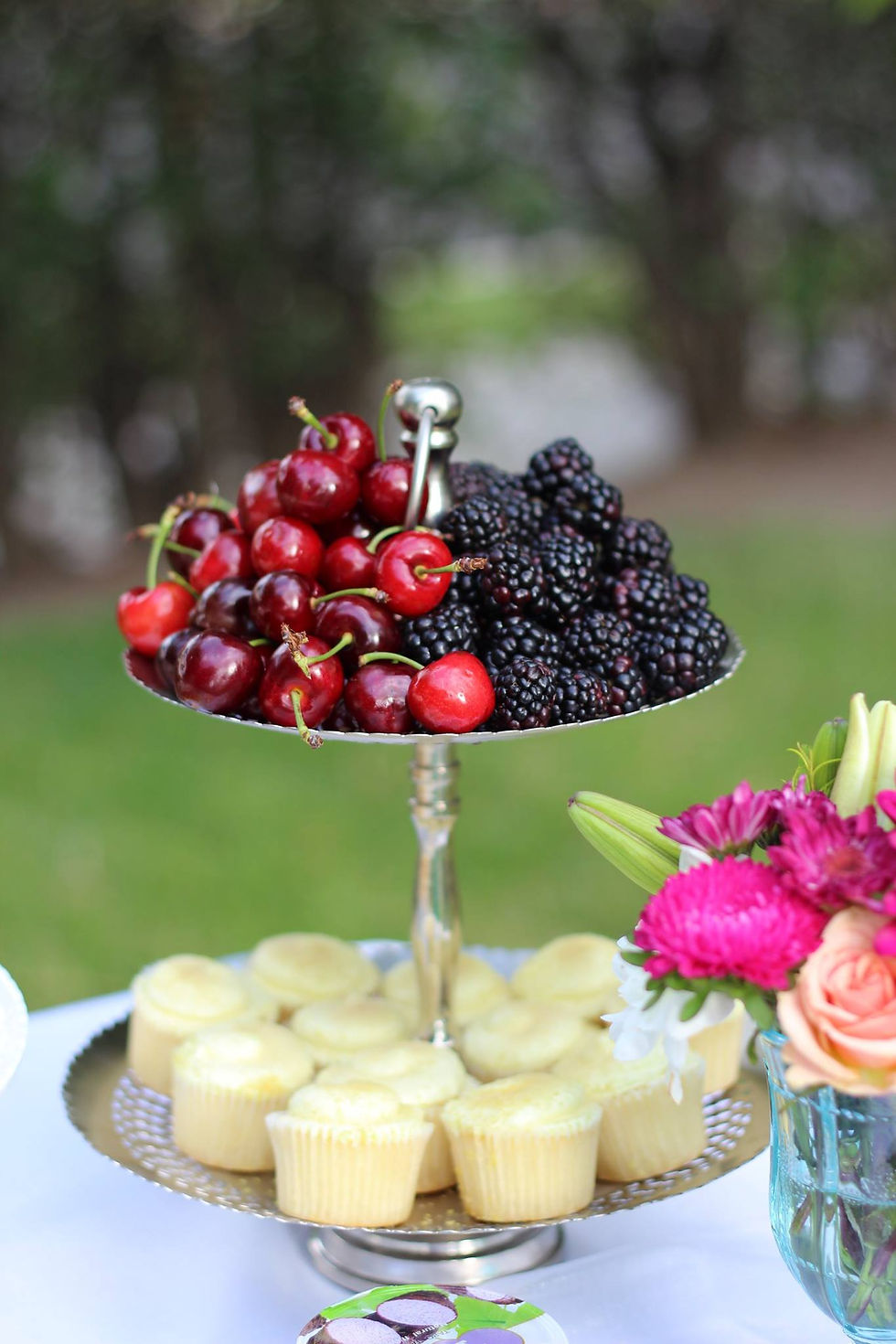 Silver cake stand with cup cake and fruits