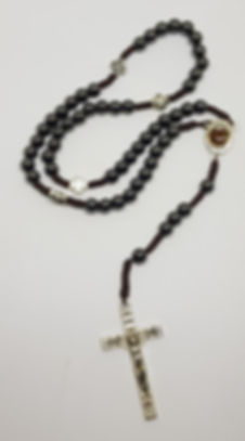 Ametiest stone with metal cross between the decades