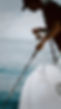 Angler holding a fishing rod off the side of a white center console boat during a calm Gulf sunset cruise with Just Fish Clearwater