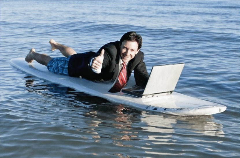 Businessman surfs with thumbs up after finding Alexy Pro Writing - top content marketing solutions.
