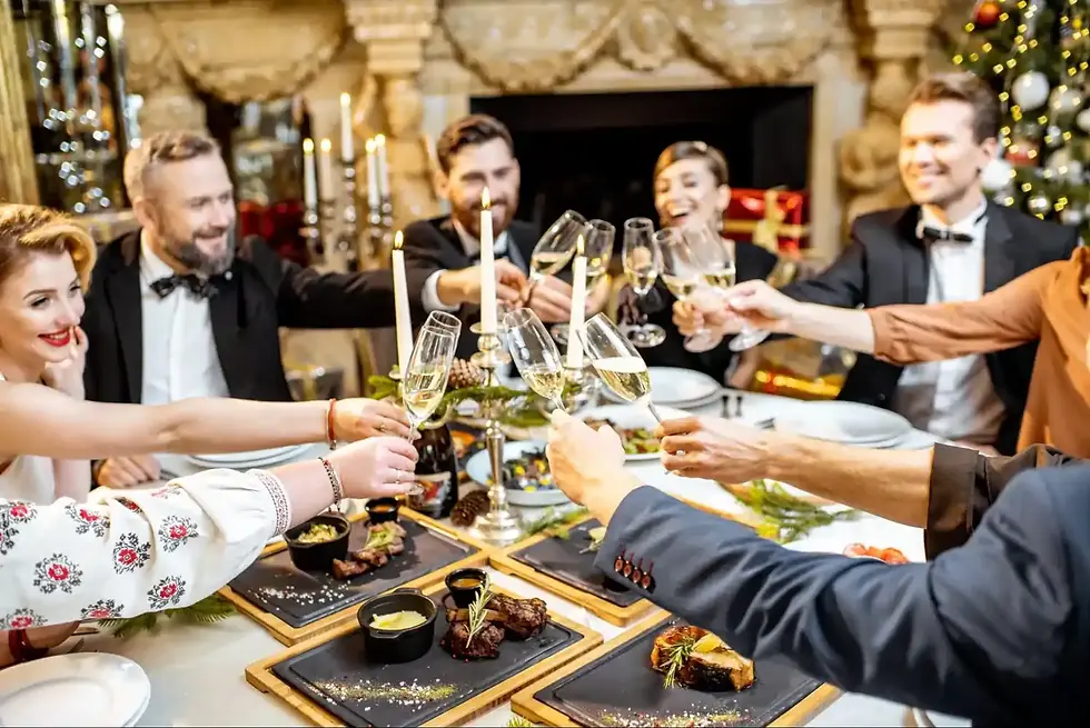Men wearing tuxedos and women wearing wedding attire toast their wine cups in celebration.