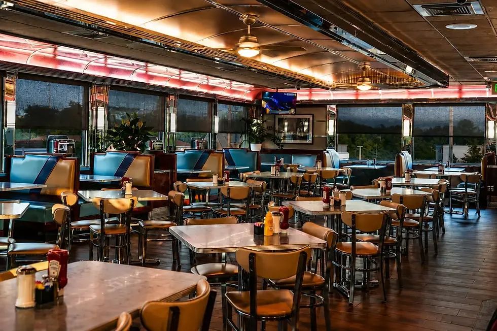 Interior view of a diner featuring tables and chairs arranged for dining.