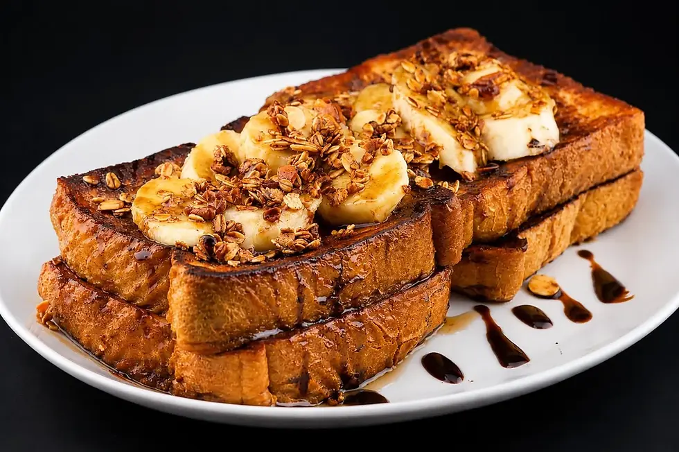 A serving of French toast on a plate, featuring banana slices and nuts, creating a visually appealing breakfast dish.