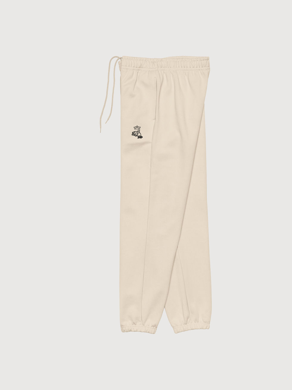 vue jambe gauche, à-plat, jogger molleton beige Dust, coupe 90's brodé logo Mascotte en noir devant