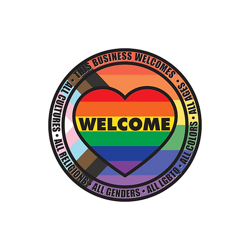 Round image with background of the progressive LGBTQIA flag which includes the trans white, pink, and blue and brown a black triangle. On top of the background is an image of a heart with rainbow strips and written in the yellow strip is the word Welcome. Around the edge of the image are the words: This business welcomes all cultures, all religions, all genders, all LGBTQ, all colors, all ages.