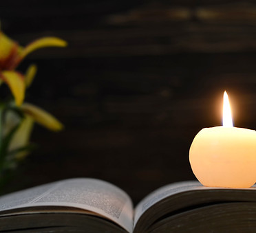 Candle, opened book and flowers  on dark wooden background.jpg