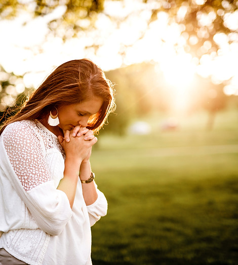 woman praying beside tree_edited.jpg