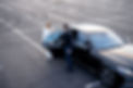 Chauffeur helps a businesswoman to get out of a car on parking lot, view from above Concep