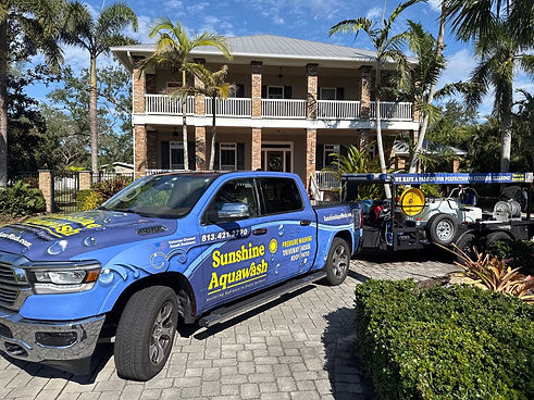 Sunshine AquaWash Truck & Trailer wrap in front of house washed in Palmetto FL