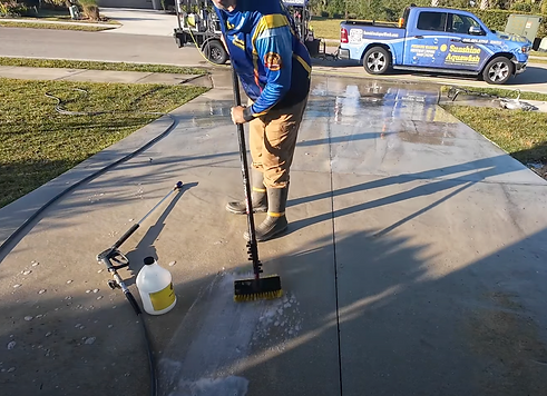 David at Sunshine Aquawash scrubbing an oil stain with Gold Assassin Degreaser