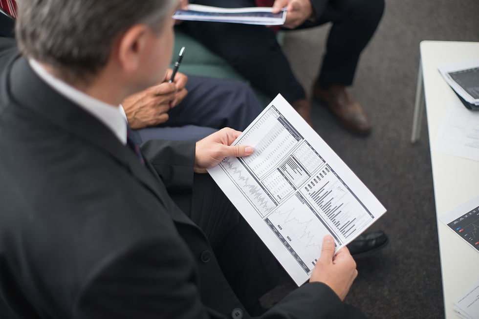 Senior finance executive reviewing a financial performance report during a leadership meeting, the type of CFO that search firms in Houston recruit