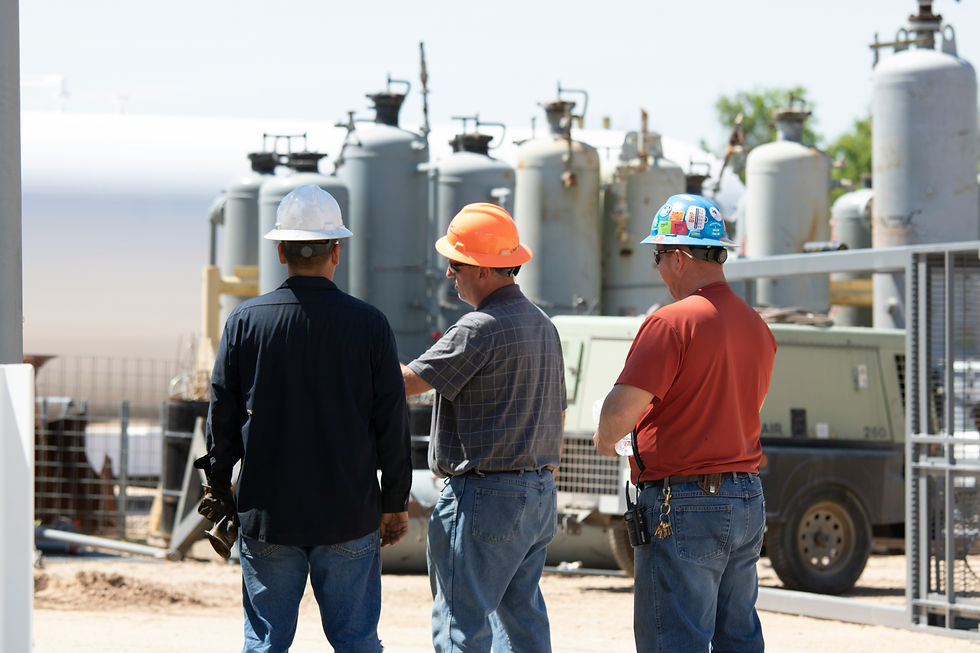 Crew in hard hats reviewing work at an industrial plant, the type of turnaround site Houston skilled trades staffing agencies supply