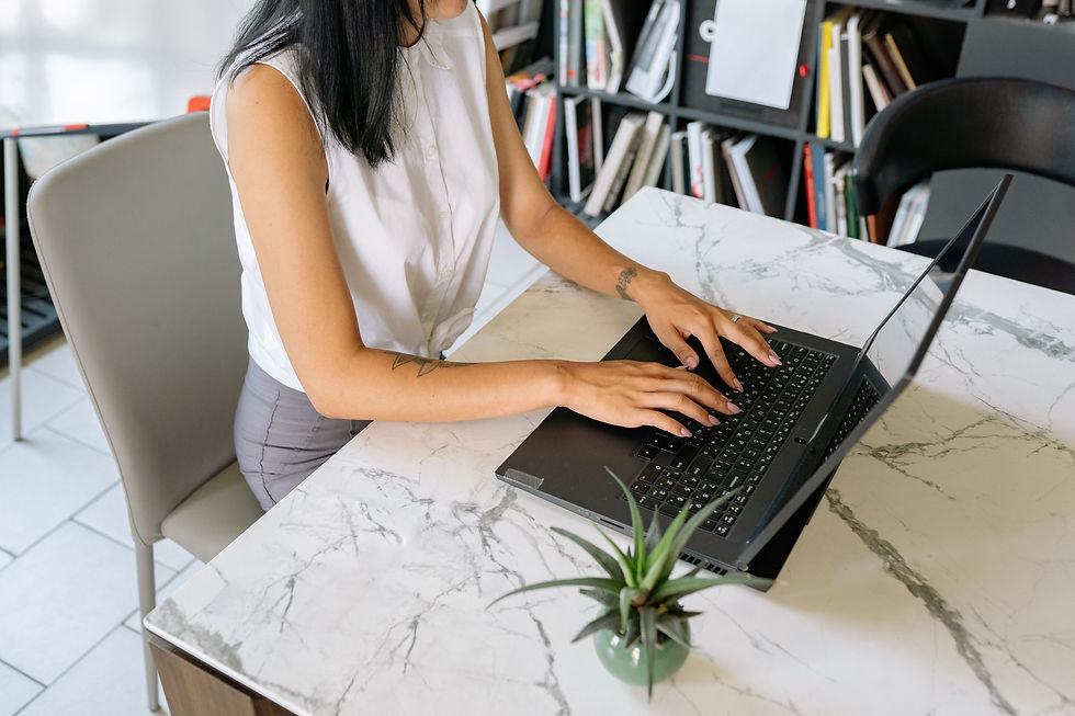 Office professional working at a laptop in a modern workspace, the type of administrative role a Houston office staffing agency fills
