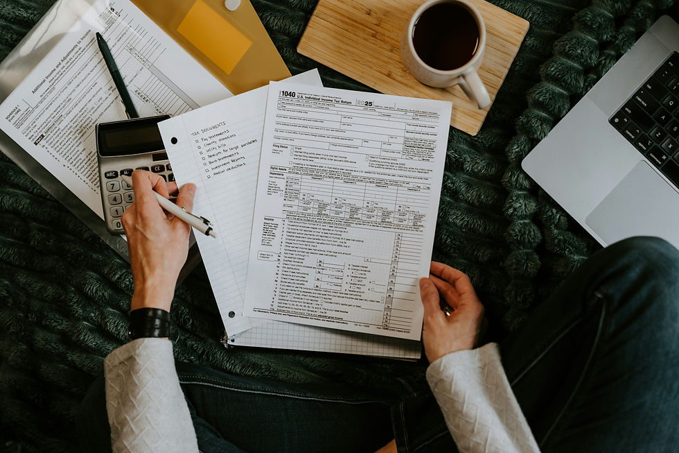 Accountant reviewing tax forms with a calculator and checklist, representing accounting roles recruiters fill in Houston