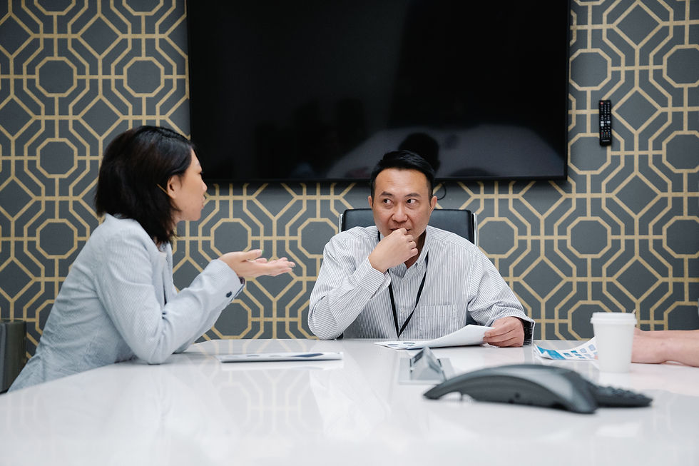 Executive recruiter and finance leader in a focused discussion across a conference table, part of the assessment process CFO search firms use in Houston
