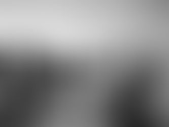 A group of fishermen gather in a circle holding up a net while many fish jump in the center.