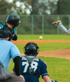 Men playing baseball game Batter getting ready to hit a pitch during ballgame on a basebal