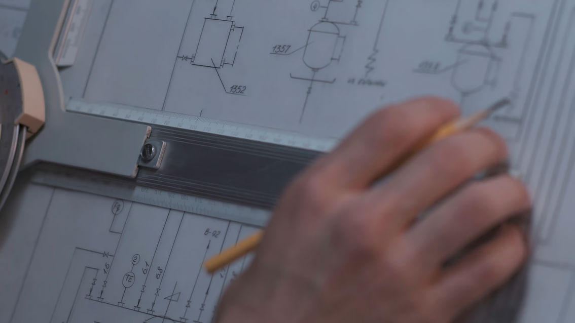 Close_Up_Of_Architect_Hand_Sketching_A_Construction_Project_At_Work_Place_original_2400243