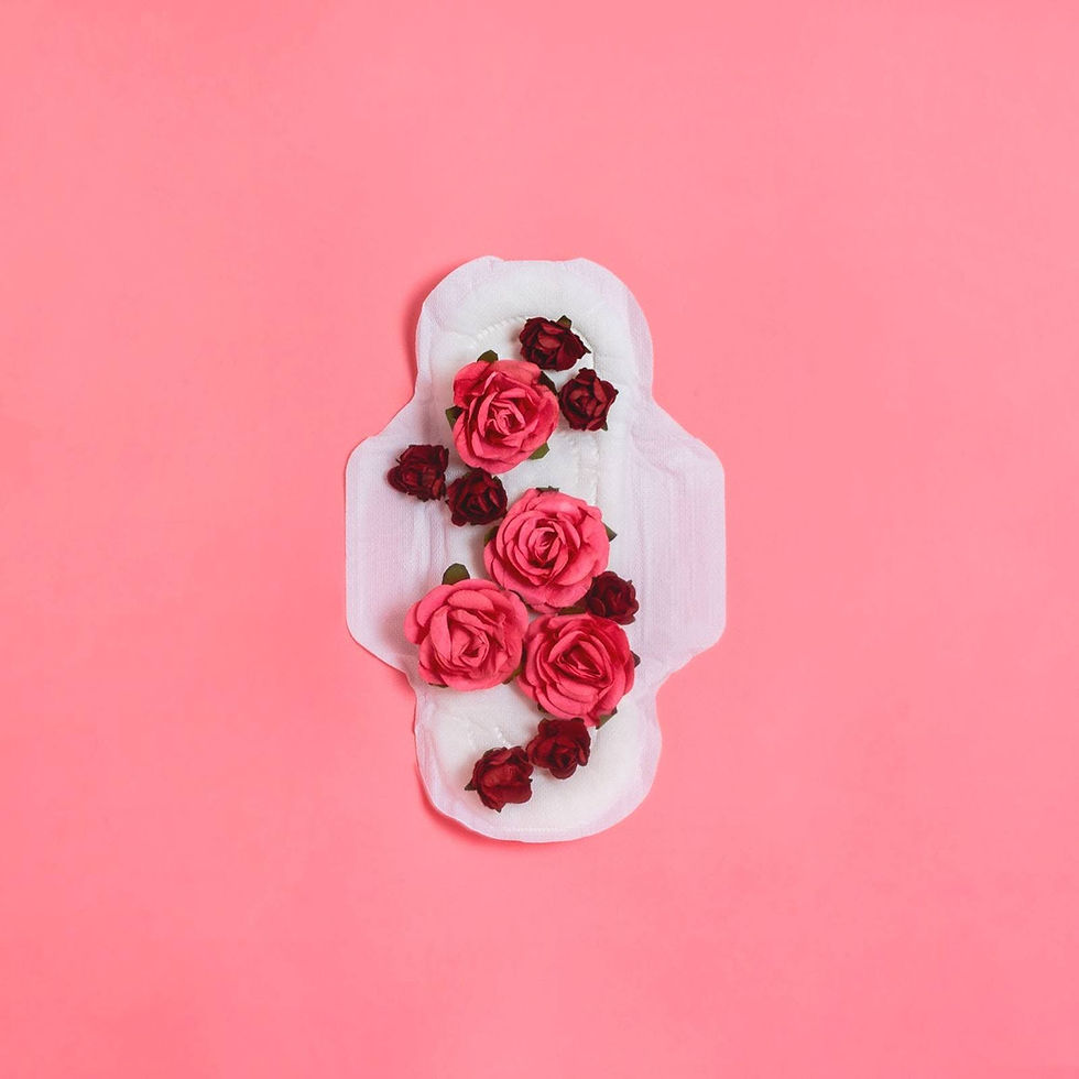 A white menstrual pad with cluster of pink and red roses on it