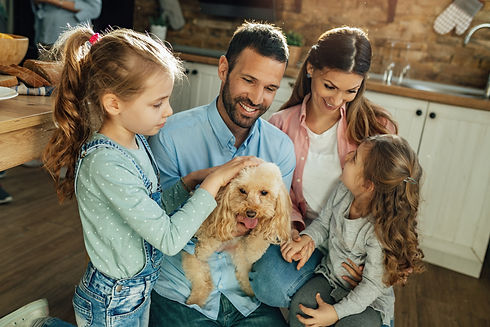 happy-parents-their-daughters-enjoying-home-having-fun-with-their-dog.jpg