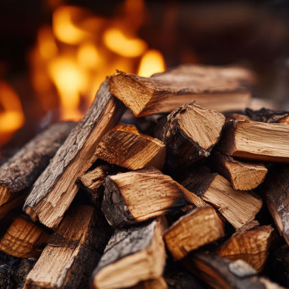 Stack of dry wood burning in a fire by Firewood Guys