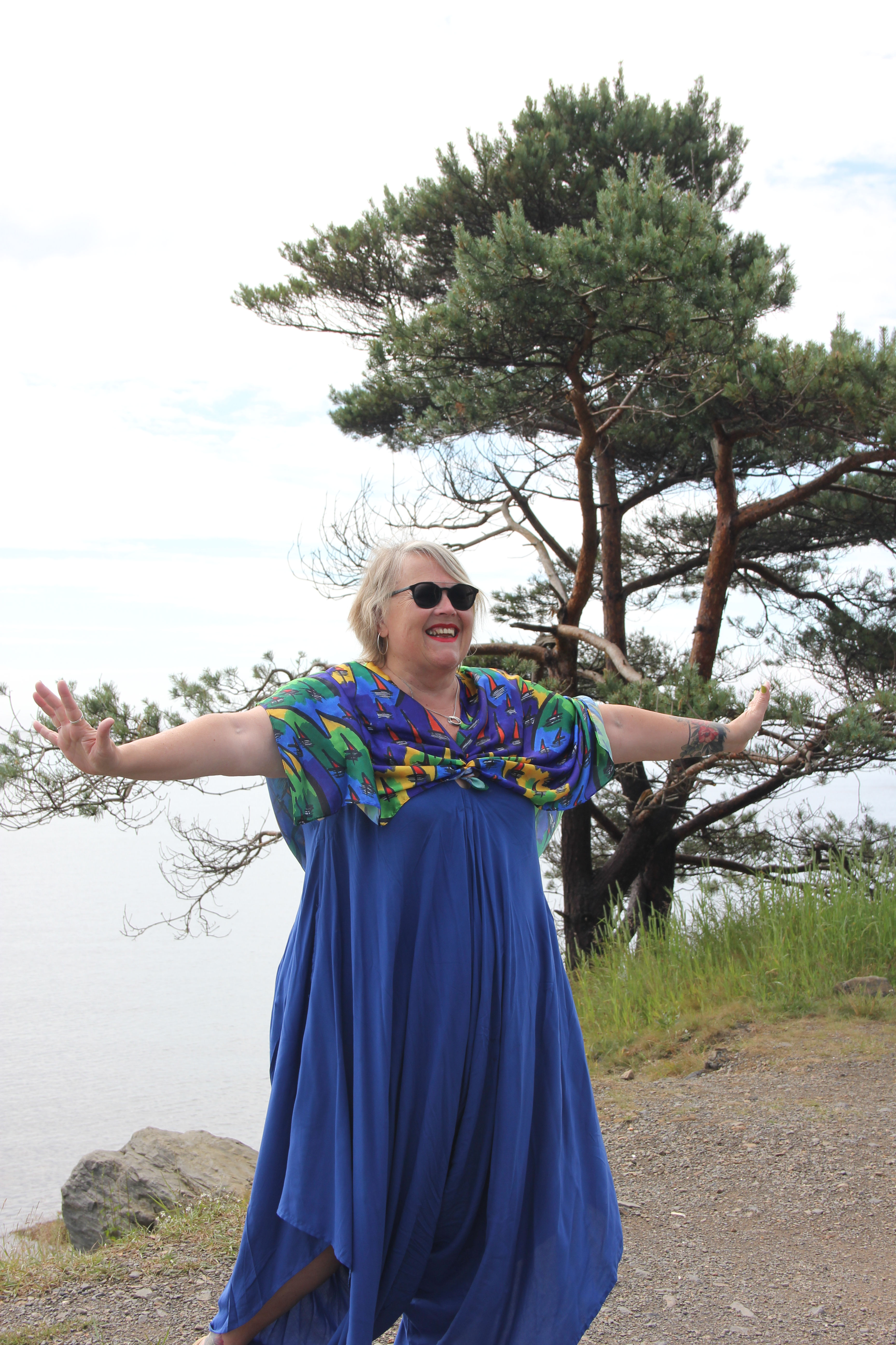 Joyful woman outdoors with arms outstretched
