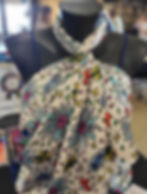 White fabric with colorful floral pattern on mannequin