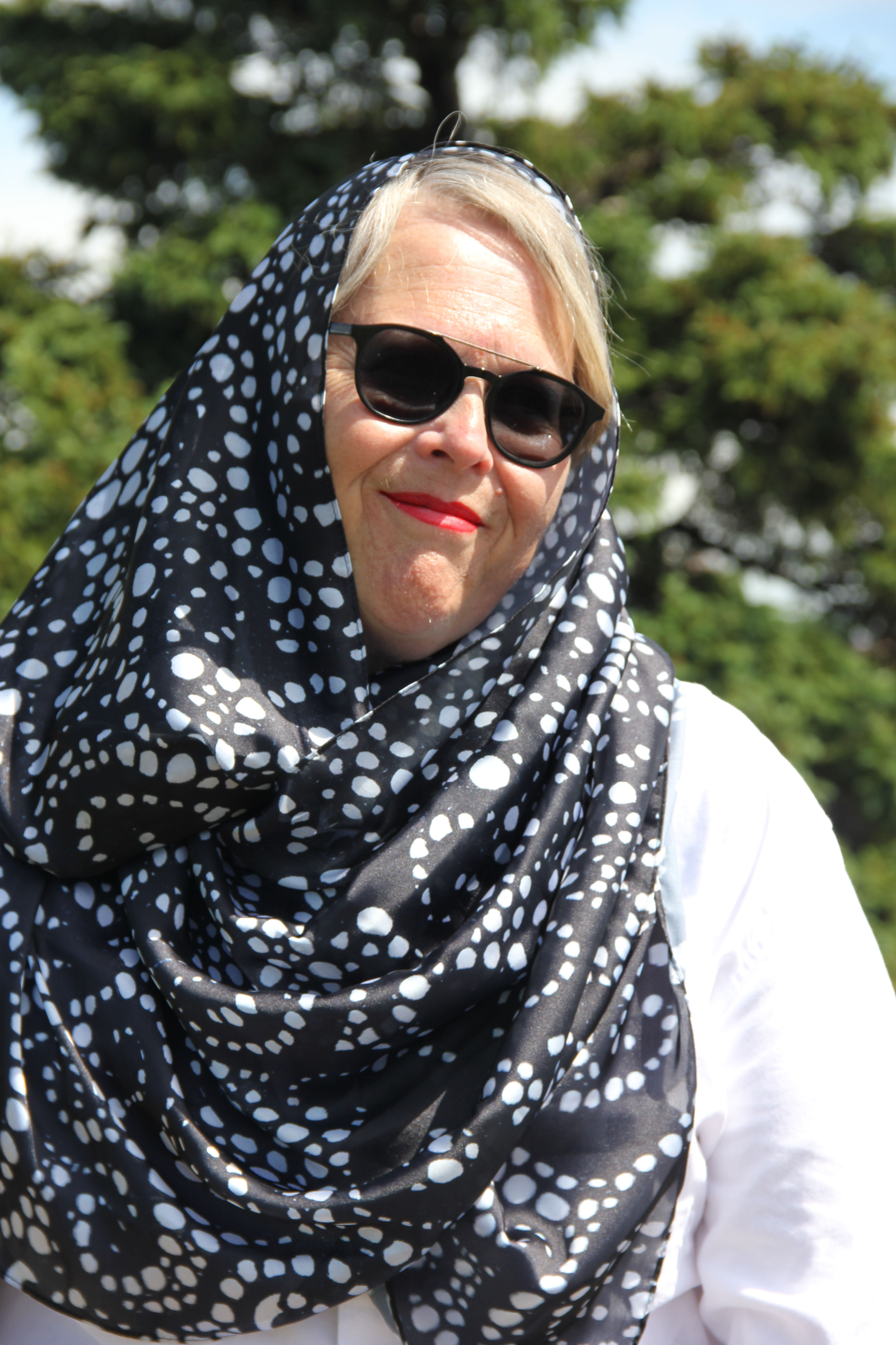 Woman models The Maple Leaf One scarf, black with white dots