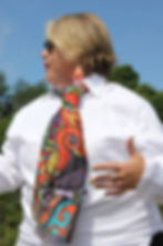 Woman wearing white shirt and vibrant abstract patterned tie