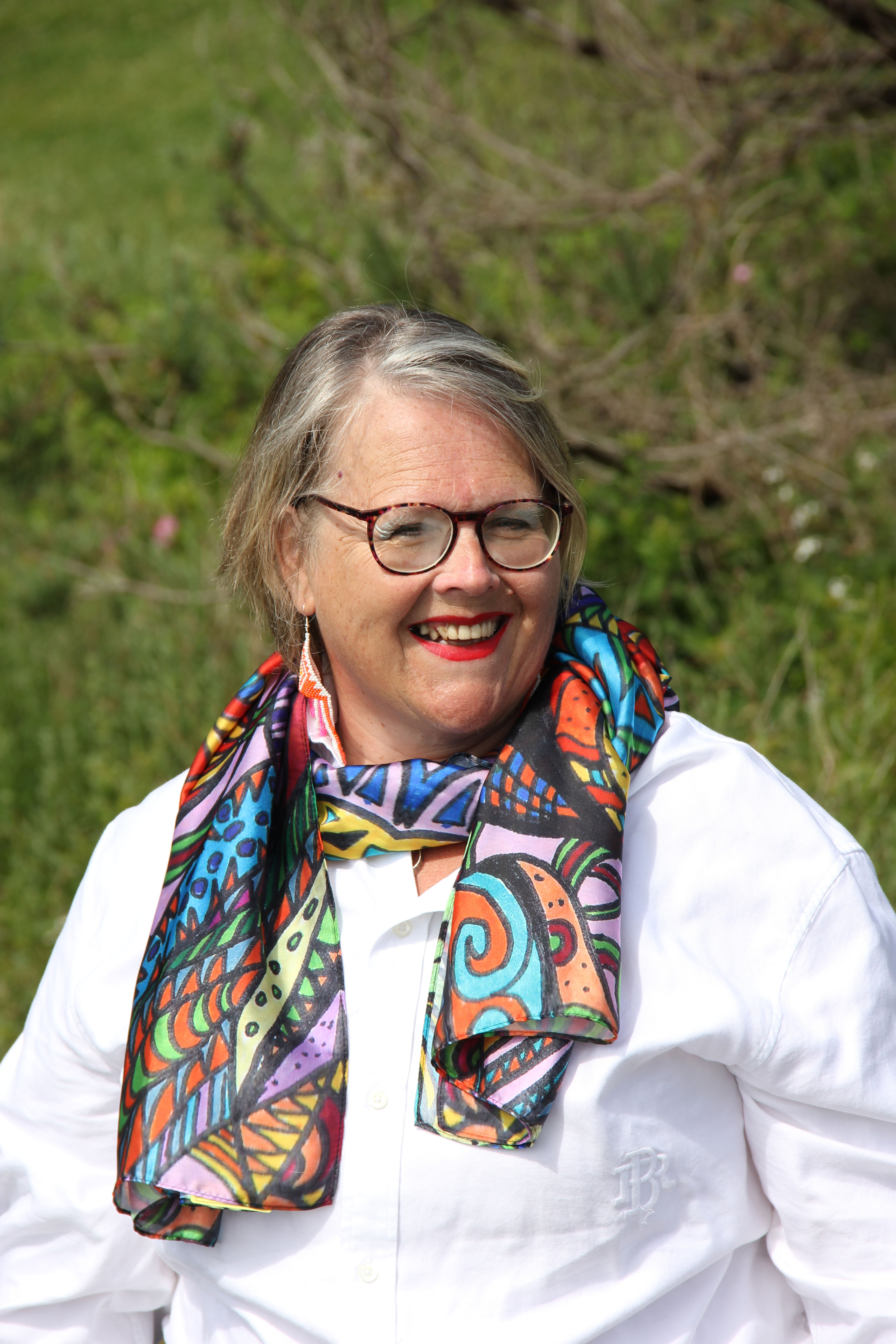 Smiling woman wearing The Maple Leaf One scarf