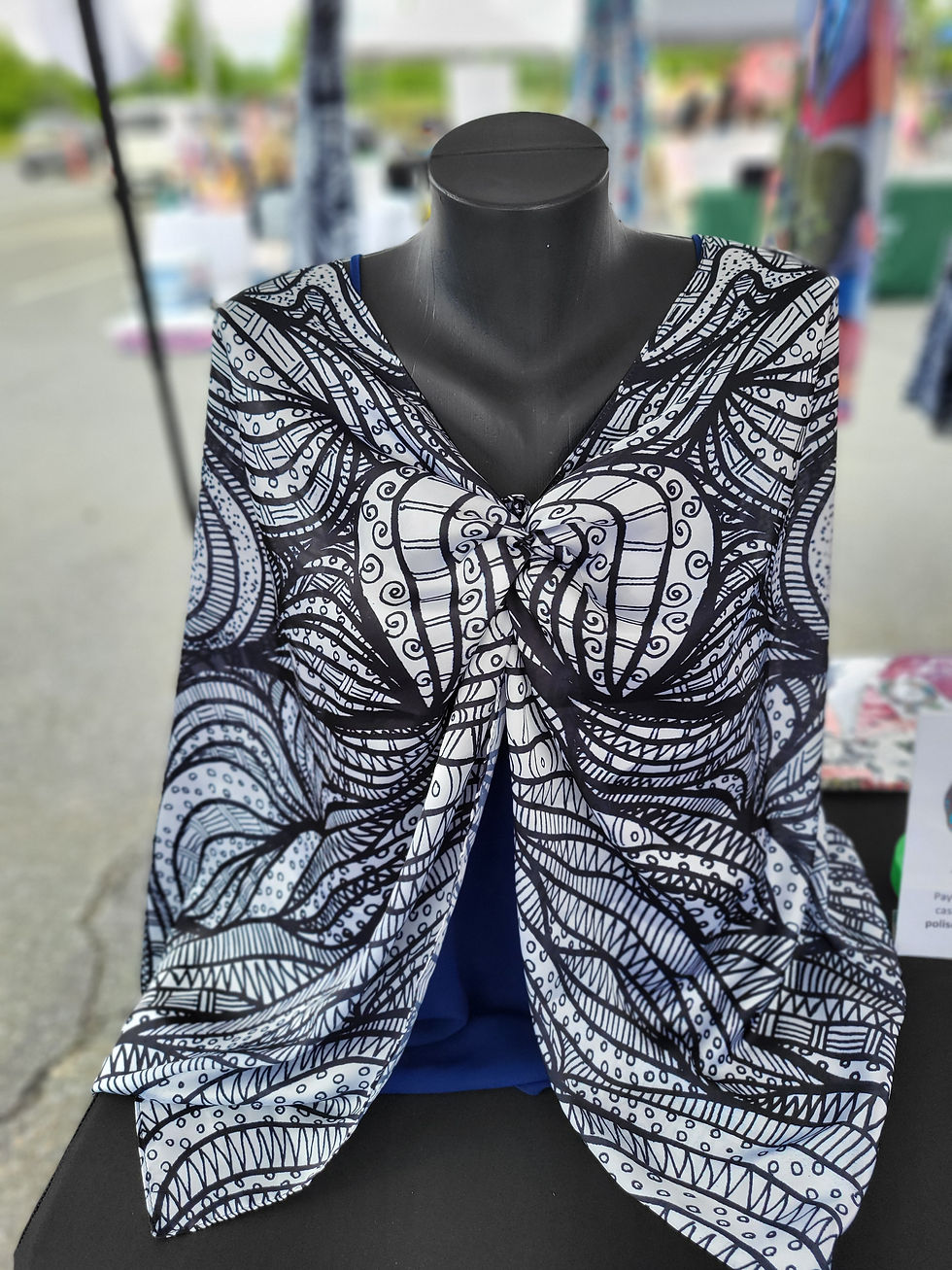 Thumbnail: Black and white V-neck top with abstract pattern