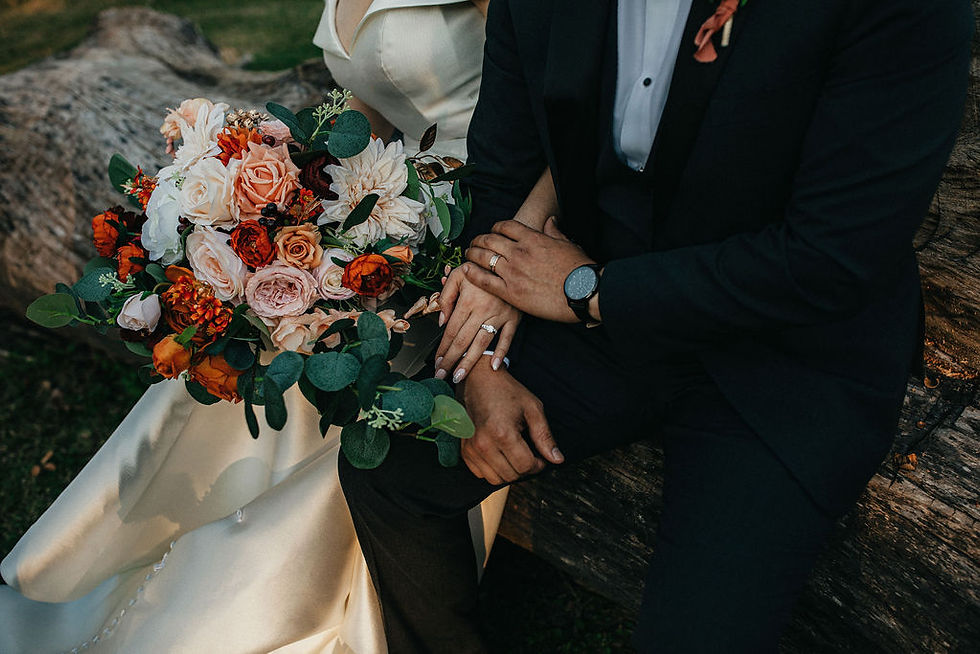 Bride and groom with orange and blush bouquet at Houston wedding.
