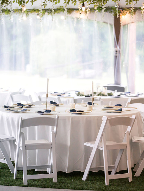 White wedding tables with candles and greenery decor in Texas, the Reserve at Cypress Creek venue.