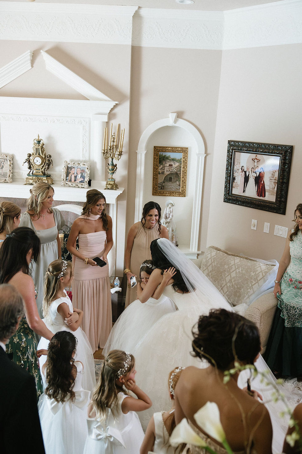 Bride hugging flower girl before Houston wedding ceremony.