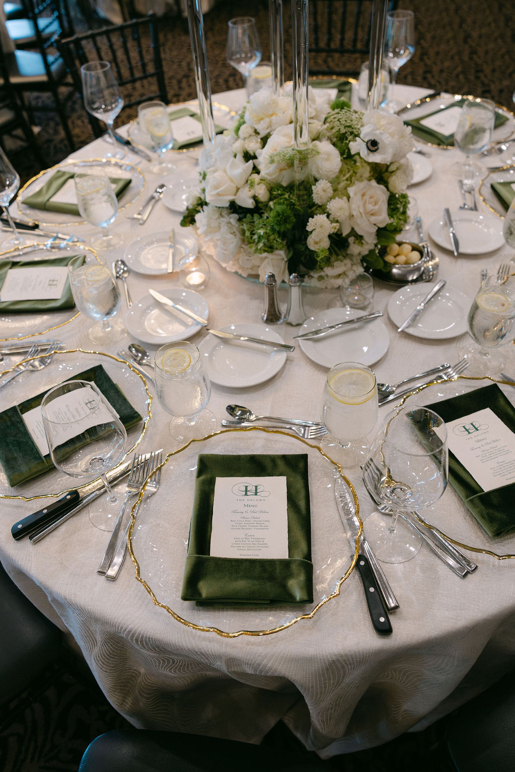 Elegant wedding table setting with white floral centerpiece.