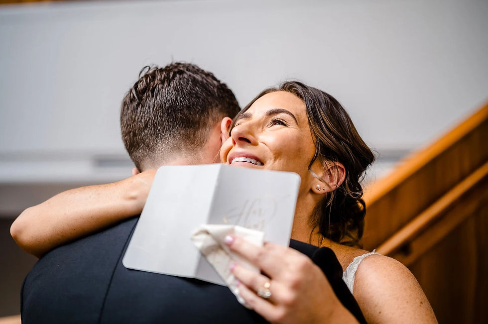 Bride joyfully hugs husband after sharing personalized gifts before the wedding ceremony