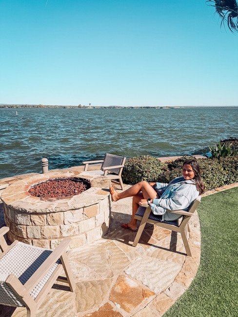 Brandi Swanson relaxing by the water on a sunny patio.