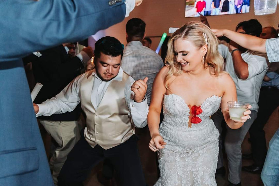 Couple dances and celebrates during wedding reception.