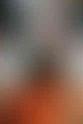 Table decor with candles, greenery, and orange flowers at Houston wedding reception.