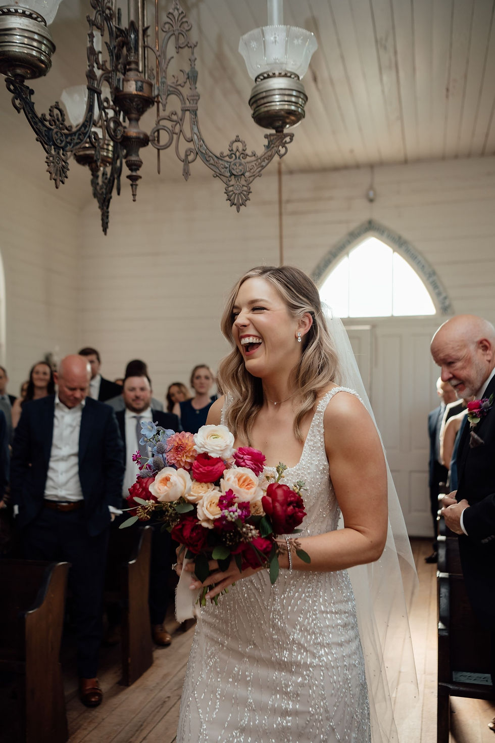 Bride laughing during her Houston wedding ceremony.