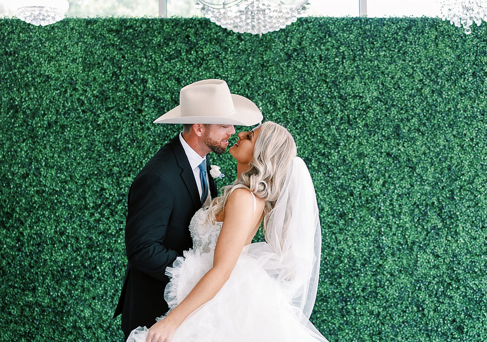 Bride and groom kiss during their wedding ceremony at Waters Edge El Lago.