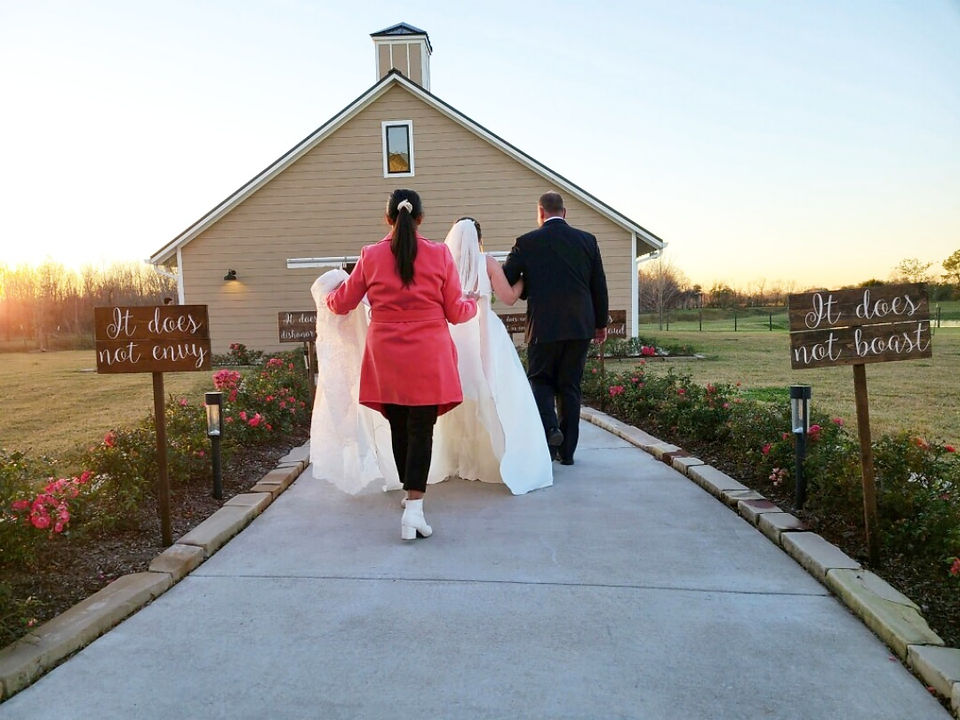 Planner assists bride and groom walking to ceremony.