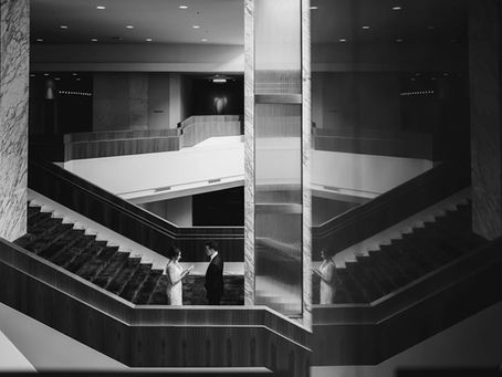 Bride and groom share intimate first look in the middle of an elegant staircase