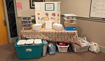 A donation table with boxes of supplies in the Good Shepherd Lutheran narthex to share with the Frederick, MD community