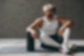 Full body smiling cheerful young strong sporty athletic sportsman man wearing white tank s