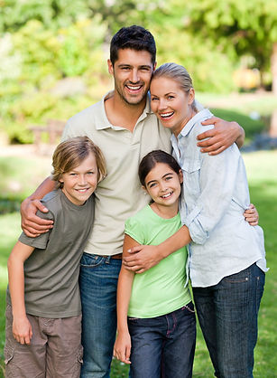 Small family hugging together, posing for picture